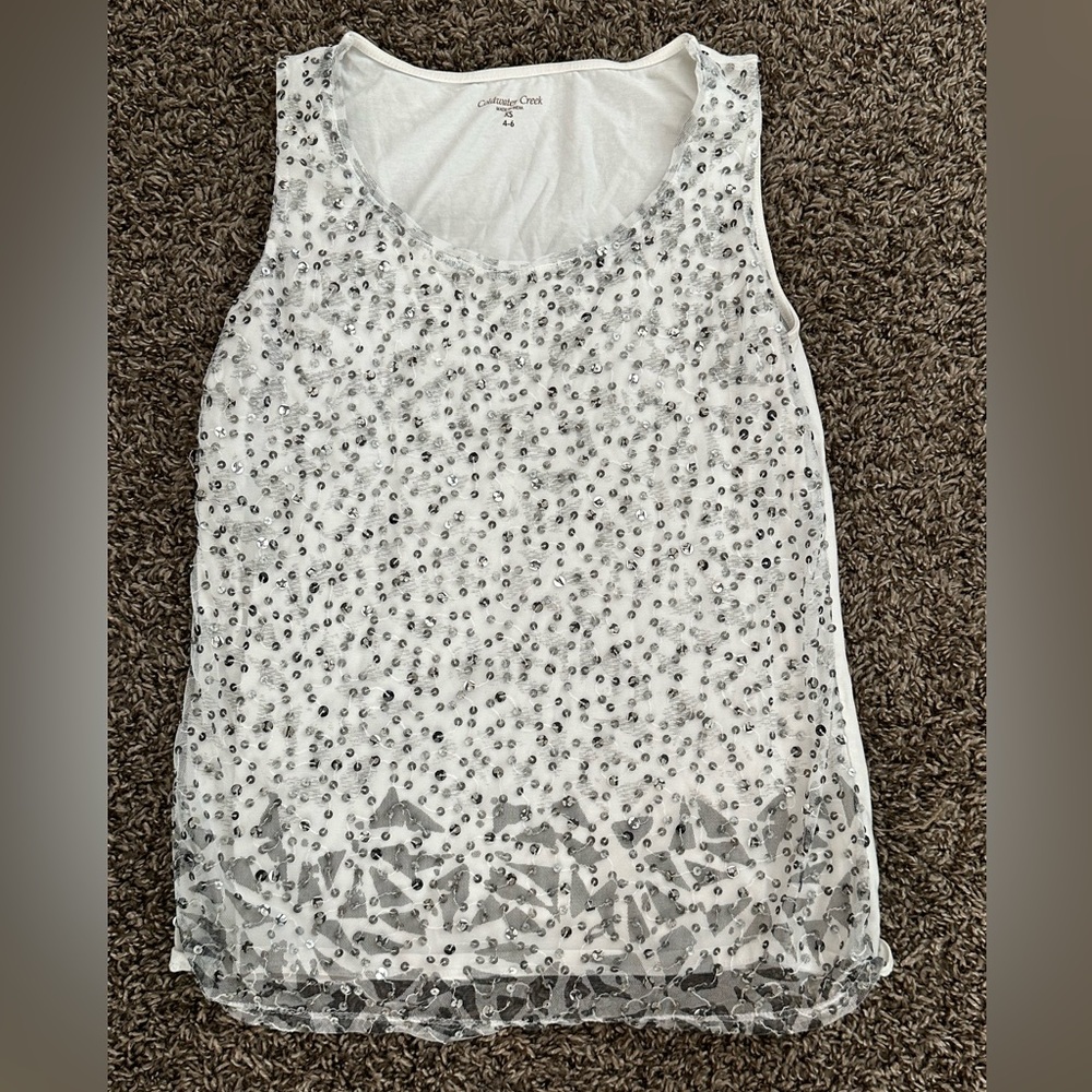 White and silver sleeveless blouse. Sequins silver on the front.